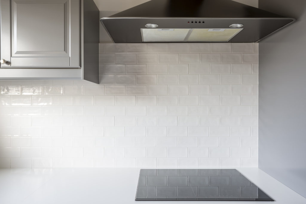 Kitchen with white brick tiles